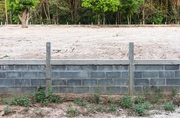 Concrete wall with sandy soil