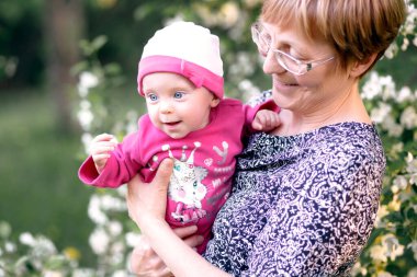 Grandmother and granddaughter child enjoying tender moment, embracing, two generations.