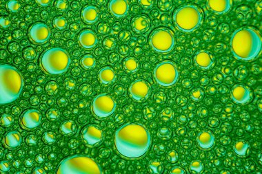 Yellow bubles on green background