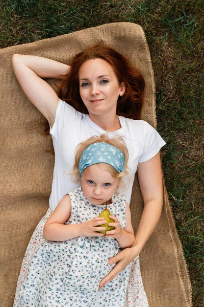 Gorgeous Mother Hugs Her Little Daughter While She Lies Top — Stock Photo, Image