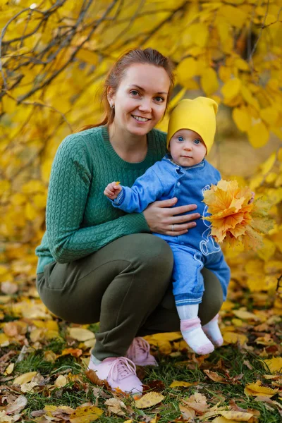 Jovem mãe e sua menina se divertem no outono — Fotografia de Stock