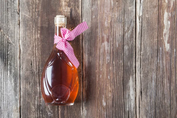 Transparent small bottle full of alcohol Stock Photo