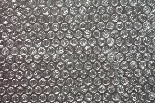 Bubble wrap texture on grey — Stock Photo, Image