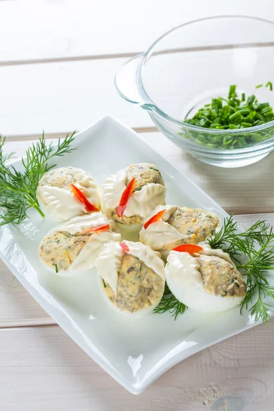 Dish with hard boiled eggs in mayonnaise parsley nad chopped chi — Stock Photo, Image