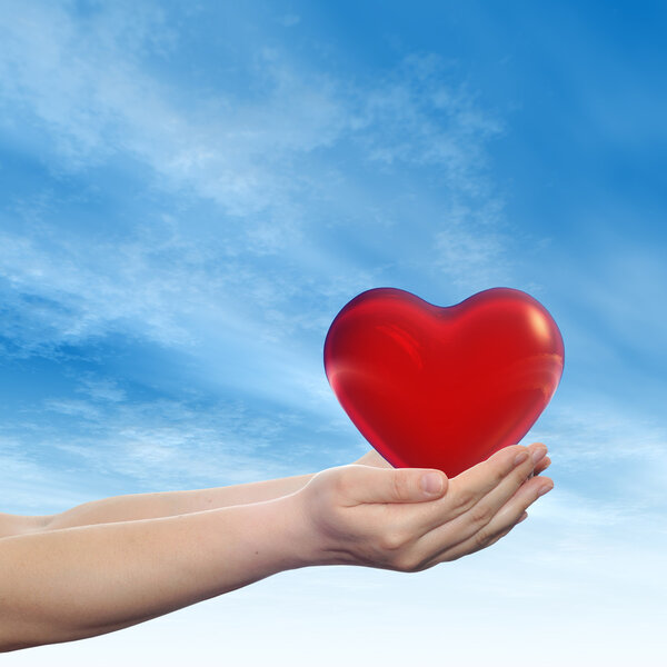 Concept or conceptual 3D red abstract heart sign or symbol held 