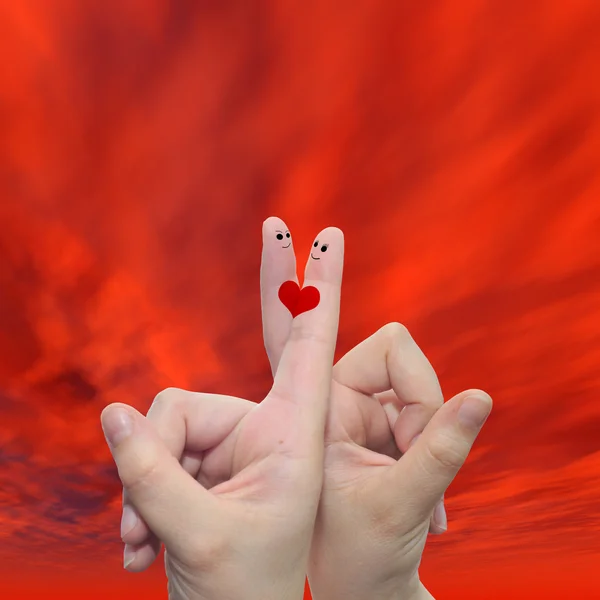 Hands with fingers and a heart painted — Stock Photo, Image