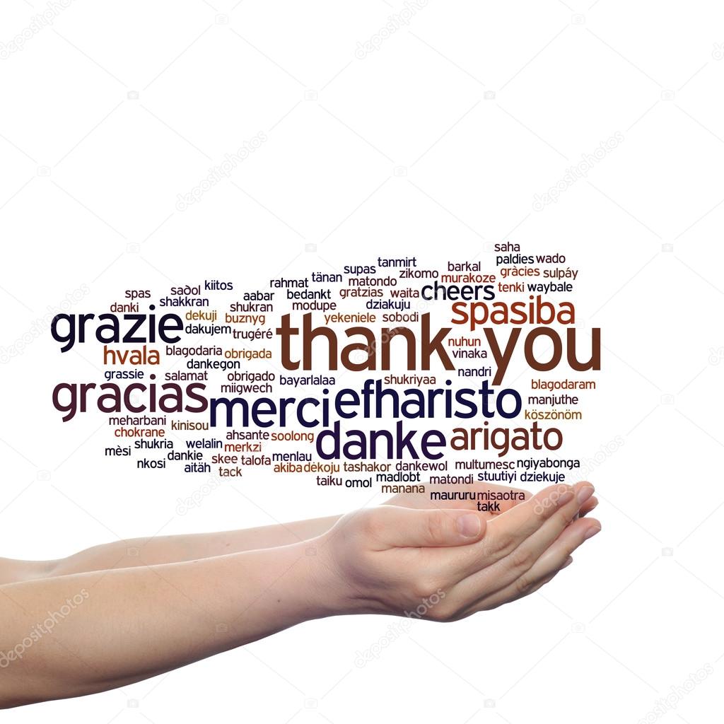 Concept or conceptual abstract thank you word cloud held in hands in different languages or multilingual for education or Thanksgiving Day