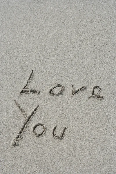 Handwritten Love you text in sand — Stock Photo, Image