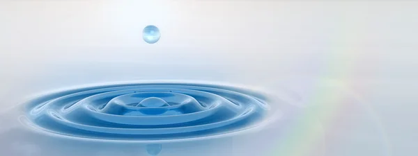 blue liquid drop falling in water