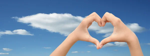 Heart symbol over blue sky background — Stock Photo, Image