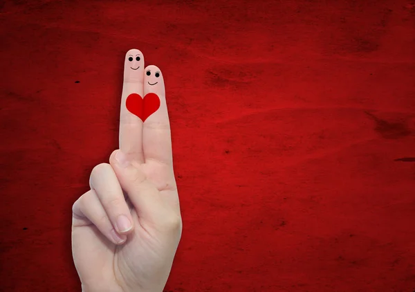 Dos manos con dedos y un corazón pintado — Foto de Stock