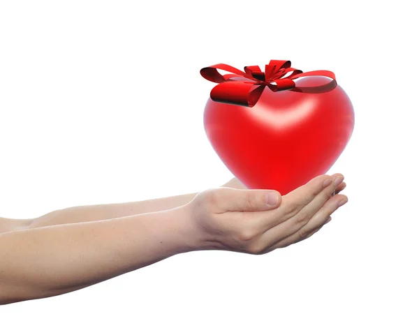 Heart with a ribbon held in human hands — Stock Photo, Image