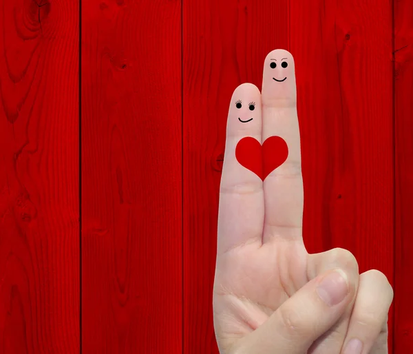 İki parmak boyalı bir kalple el — Stok fotoğraf