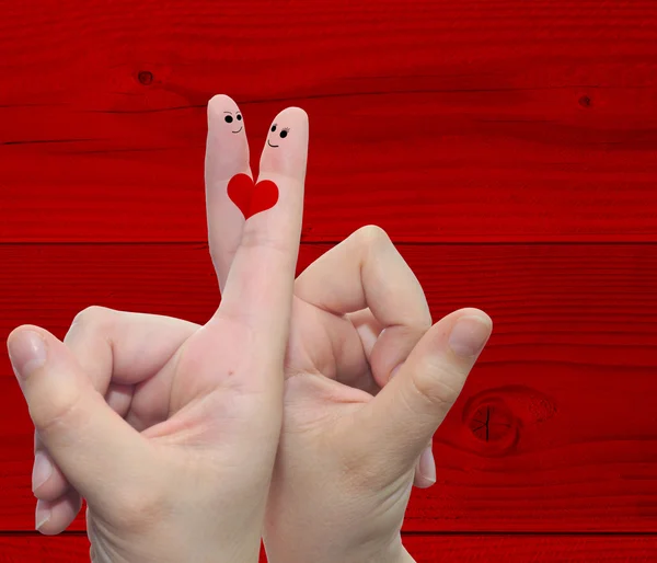 Two hand fingers with a heart painted over a red wood pattern vintage  background — Stock Photo, Image