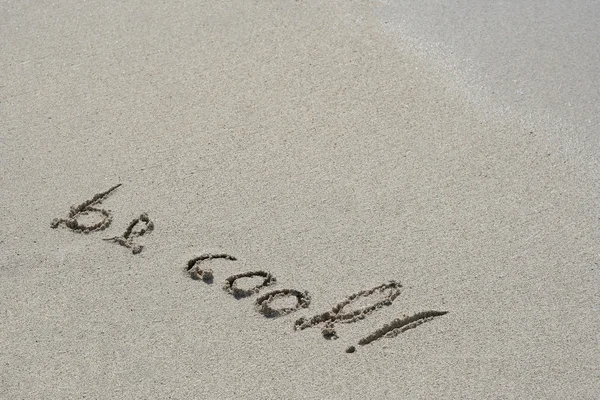 Concept or conceptual hand made or handwritten text in sand on a beach in an exotic island — Stock fotografie