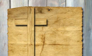 Concept or conceptual Christian cross cut in an old grungy or vintage paper