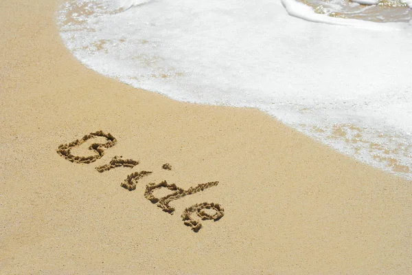 Concept or conceptual hand made or handwritten bride text in sand on a beach in an exotic island — Stok fotoğraf