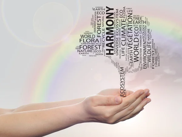 Concept or conceptual black harmony ecology text word cloud tree in man or woman hand on rainbow sky background — Φωτογραφία Αρχείου