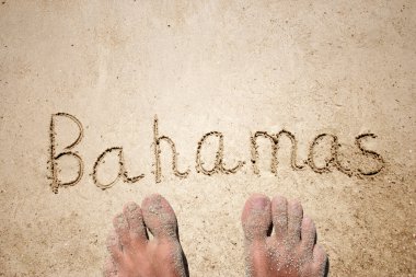 Concept or conceptual hand or handwritten Bahamas text in sand