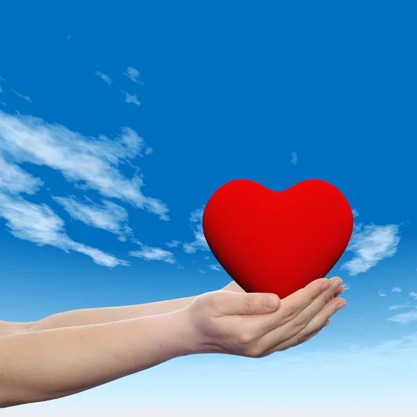 Concept or conceptual 3D red abstract heart sign or symbol held in hands by a woman or child over a nice blue sky background — Stock Photo, Image