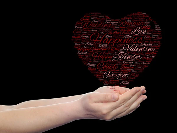 Koncept nebo konceptuální červené lásky nebo Valentýn wordcloud text v obrazci symbol srdce v rukou izolovaných na černém pozadí — Stock fotografie