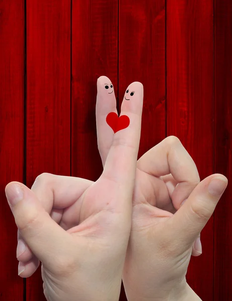 Two hand fingers with a heart painted over a red wood pattern vintage  background — Stock Photo, Image