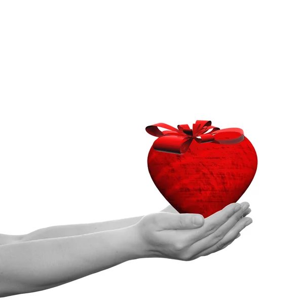 Heart with a ribbon held in  hands — Stock Photo, Image