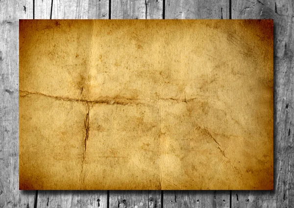 Vintage old grungy paper banner over ancient wood texture background — Stock Photo, Image