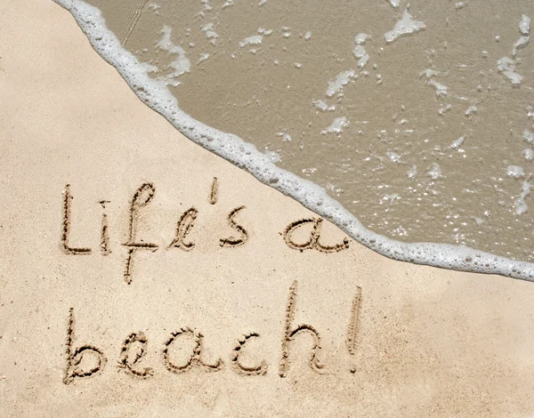 Life's a beach text in sand on a beach — Stok fotoğraf