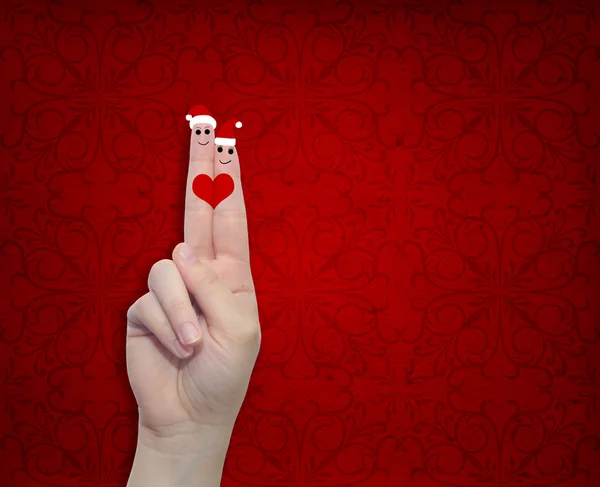 Woman fingers in love with Christmas hats — 图库照片