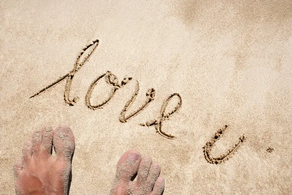 Conceptual love you handwritten text in sand on a beach in an exotic island — Stock Photo, Image