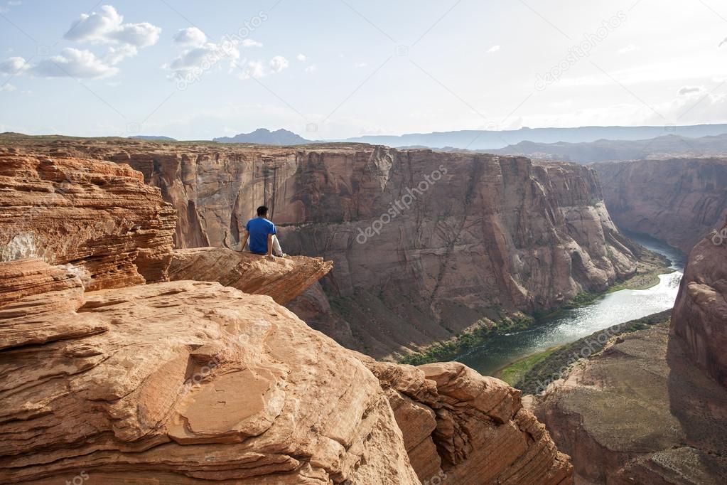 Person overlooking Horseshoe Bend in Colorado River near the town of Page, Arizona