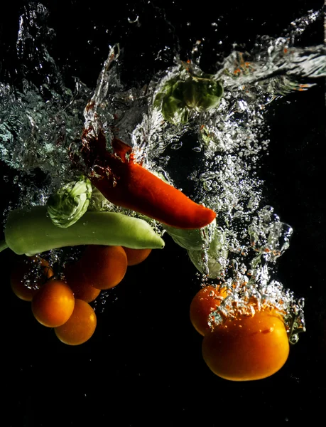 Frash Vegetables splash in to the water Stock Image
