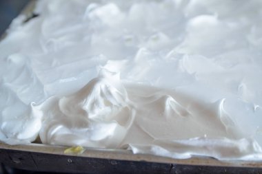 Ev yapımı Cremeschnitte tavada ve üzerinde beyaz krema ile tatlı dişleri tarafından dilimlenip yenmeyi bekliyor.