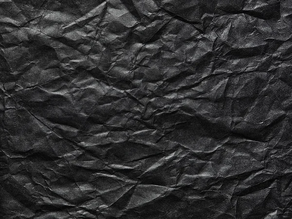 Papel crumpled preto como um fundo — Fotografia de Stock