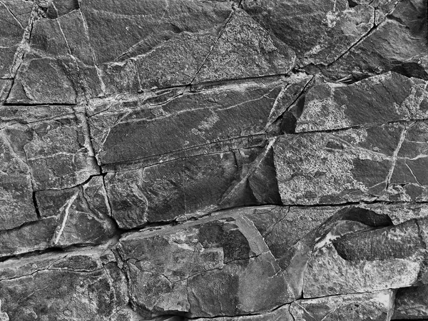 Black and white stone rock with cracks in the background — Stock Photo, Image