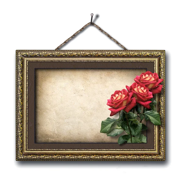 Vintage picture frame and a bouquet of red roses — Stock Photo, Image