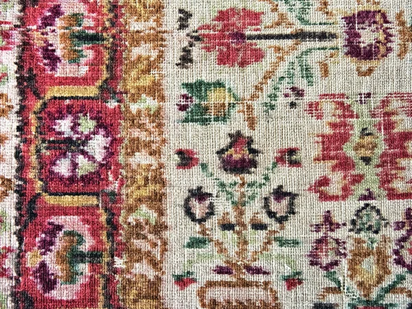 Old faded carpet with floral ornament closeup — Stock Photo, Image