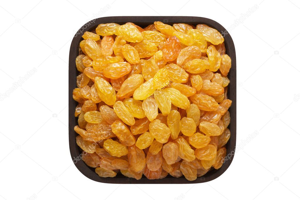 golden raisins in wooden bowl closeup. vegetarian food isolated on white.