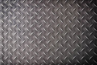 kaba çelik desenli, kıvrımlı desenli. koyu metal arkaplan.