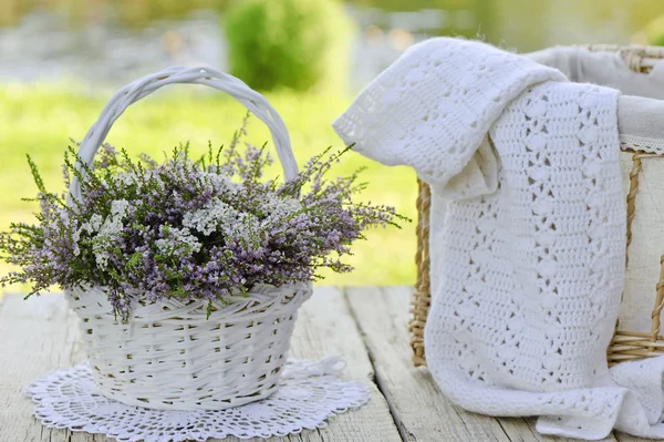 Bouquet of flowers in basket and scarf — Stock Photo, Image