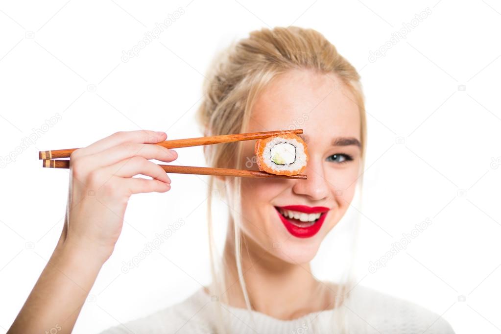 White-haired girl eating sushi with a chopsticks, isolated