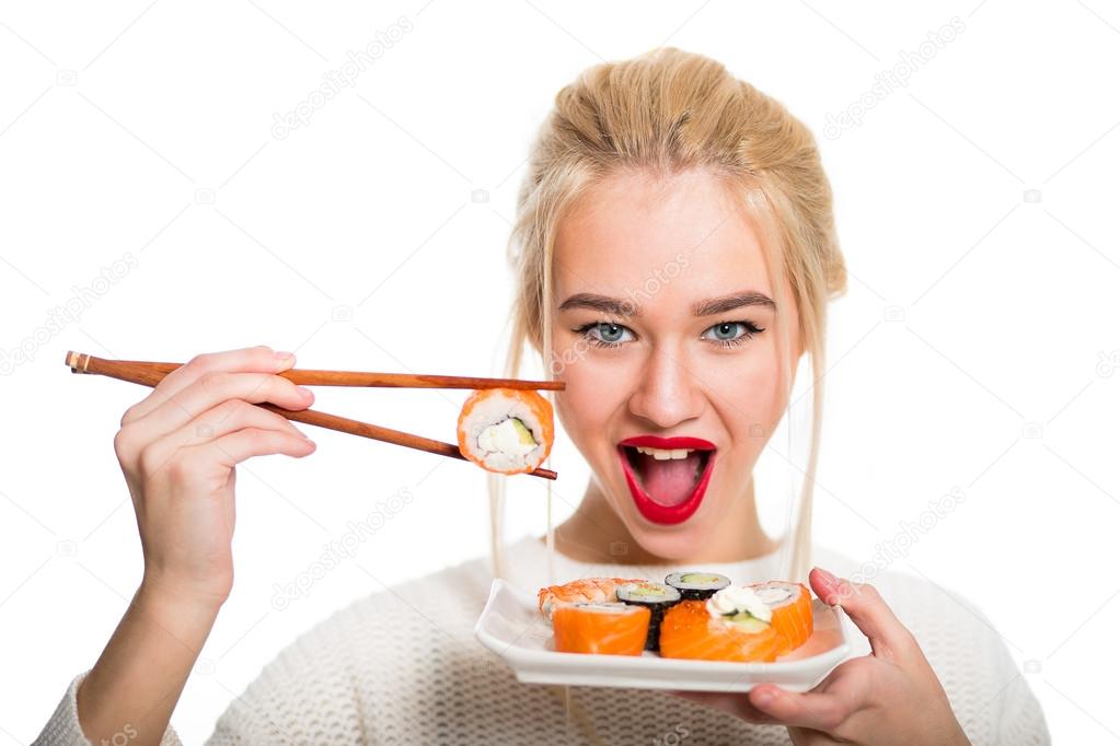 White-haired girl eating sushi with a chopsticks, isolated