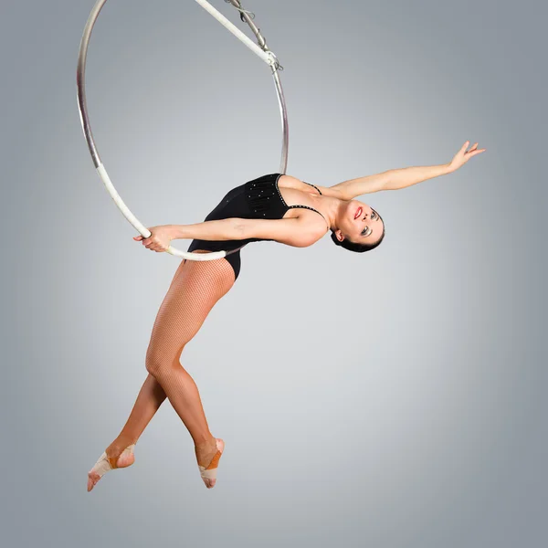 Plastic beautiful girl gymnast on acrobatic circus ring in flesh — Stock Photo, Image