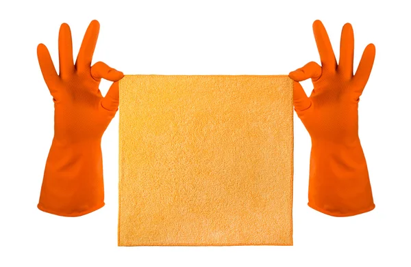 Mano in guanto di gomma arancione tiene uno straccio arancione - pulizia della casa Fotografia Stock