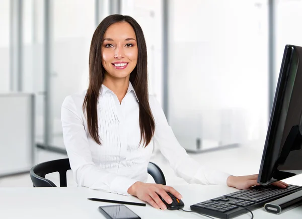 Portrait of a young business woman using computer at office Royalty Free Stock Images