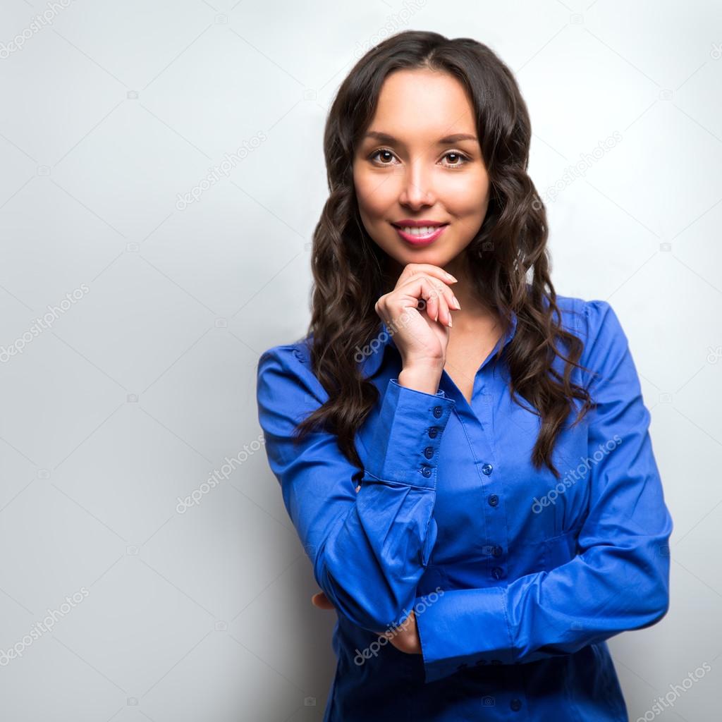 Business woman portrait with crossed arms isolated on gray backg