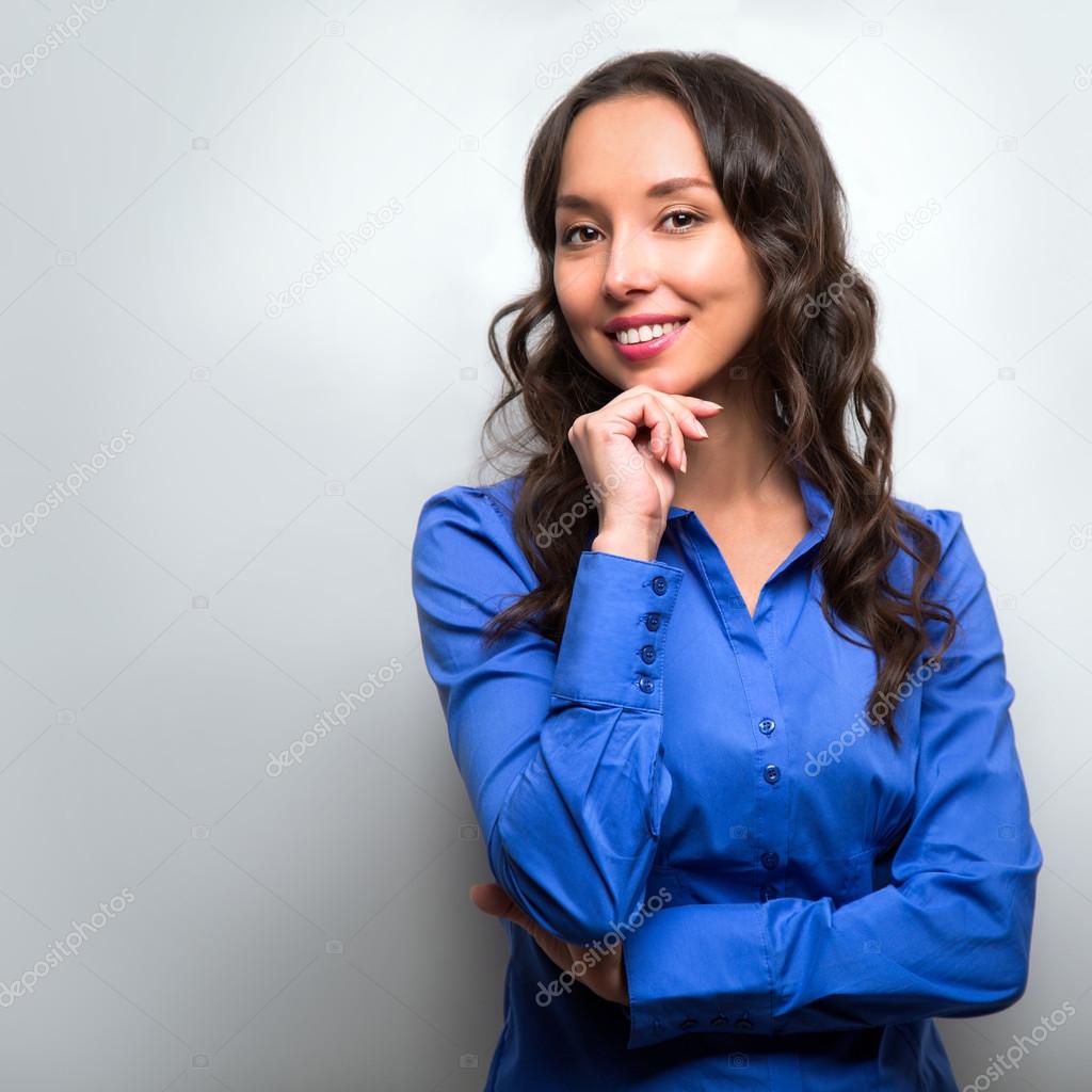 Business woman portrait with crossed arms isolated on gray backg