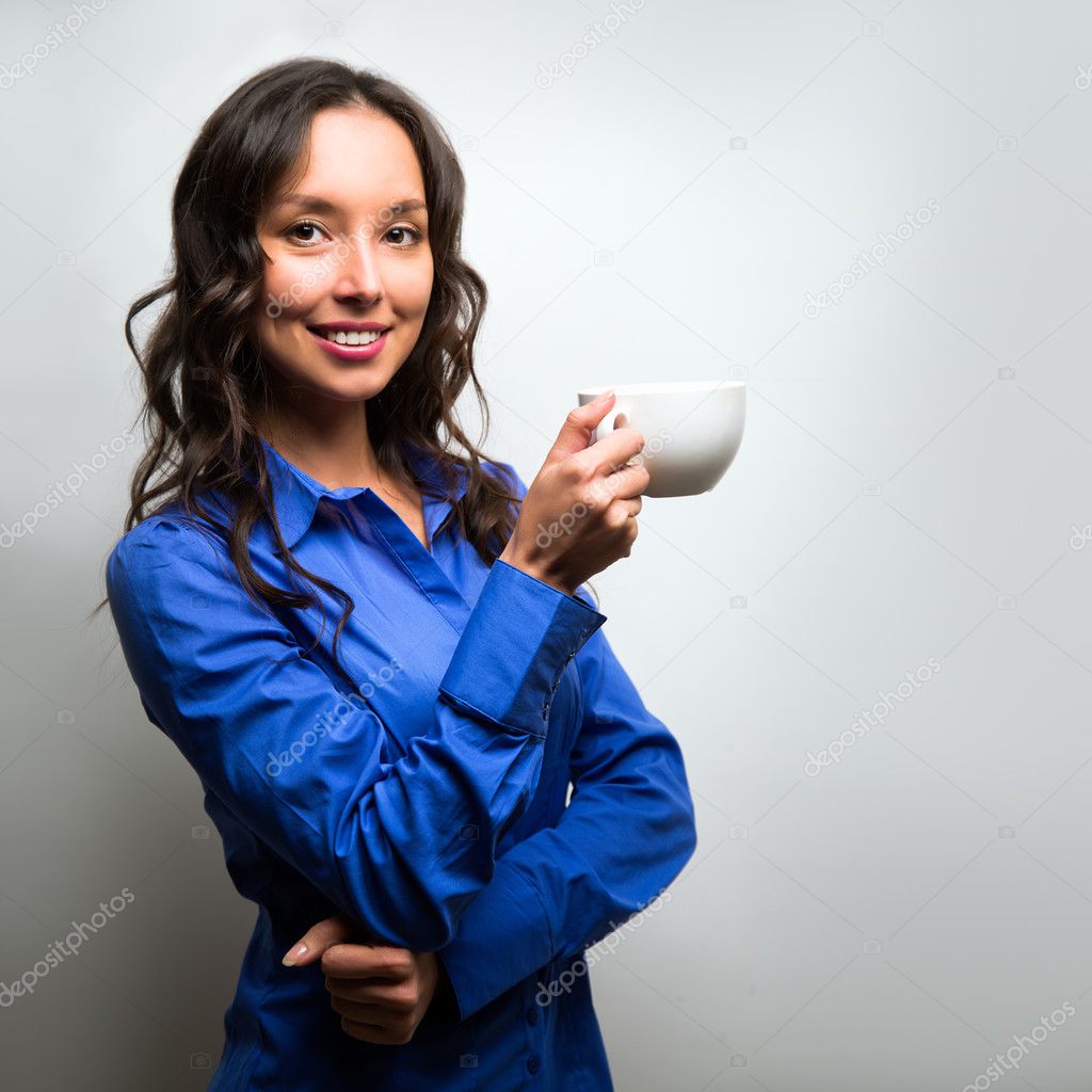 Business woman portrait with cup and saucer, isolated. Female mo