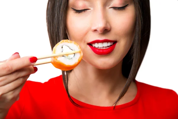 Young woman holding sushi with a chopsticks, isolated on white — Stock Photo, Image